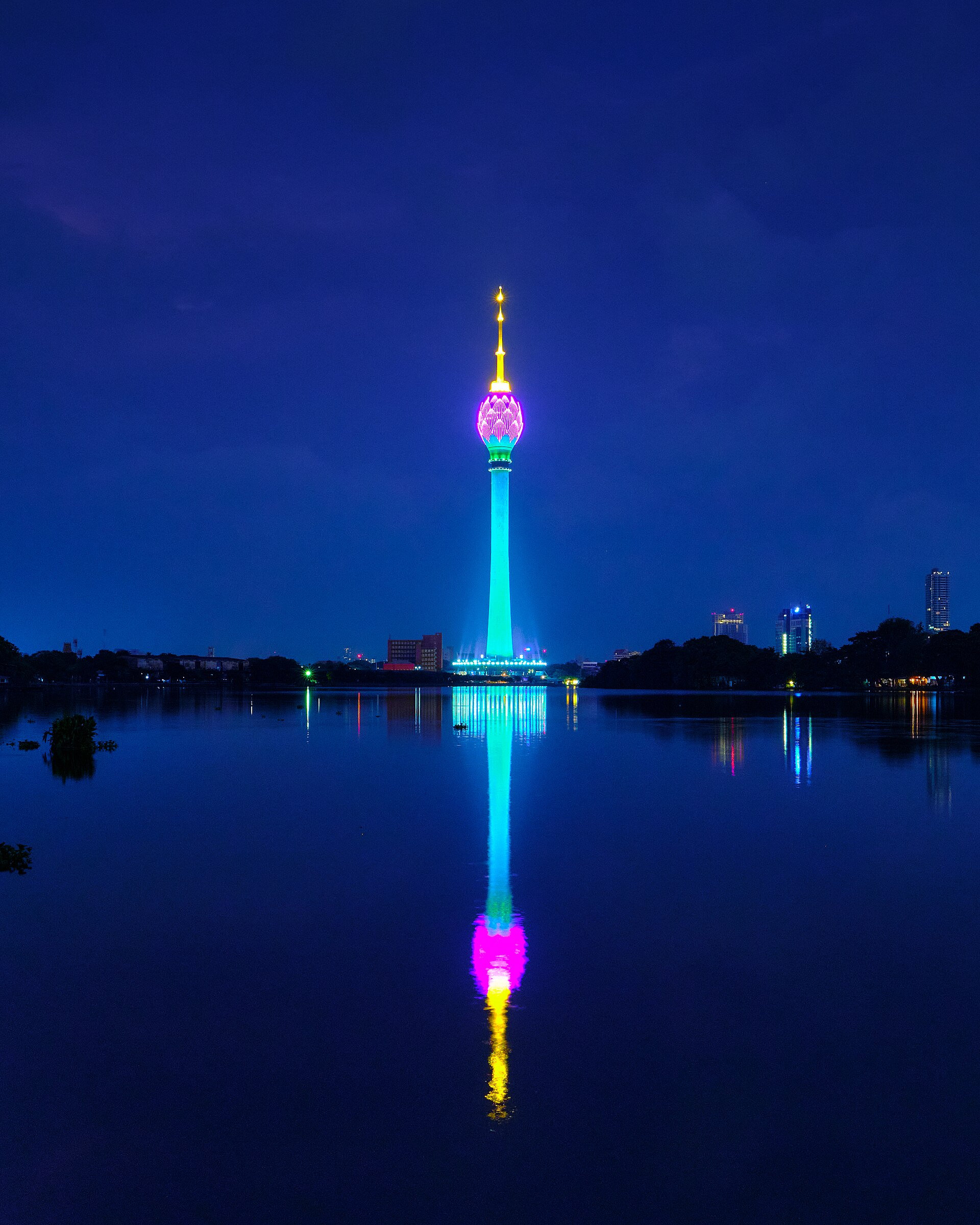 The Lotus Tower glowing over the still waters of Beira Lake in Colombo at dusk